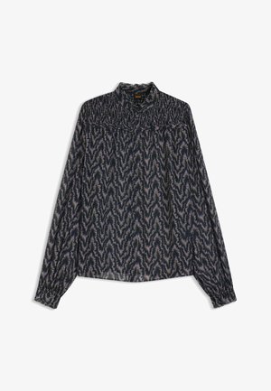 Blusa a maniche lunghe in tessuto leggero con un motivo a zigzag blu scuro e scollatura arricciata. Presenta chiusura con bottoni e polsini arricciati.