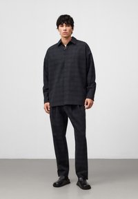 Donkere geruite lange mouwen shirt met een kraag en een rechte snit, gecombineerd met bijpassende broeken. Gladde stofstructuur en minimalistisch ontwerp.