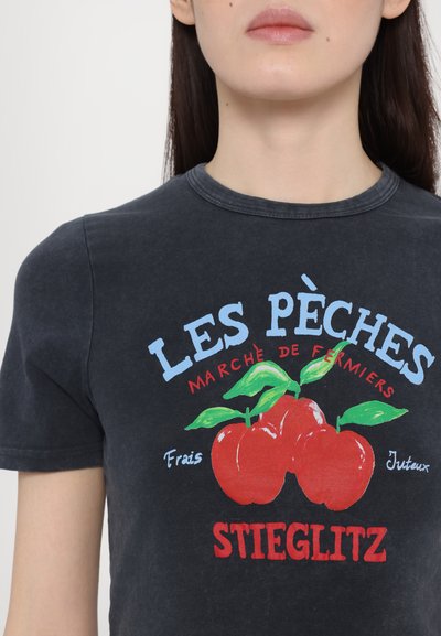 Black cotton t-shirt featuring a graphic print with red cherries and blue text, designed with a crew neckline and short sleeves.