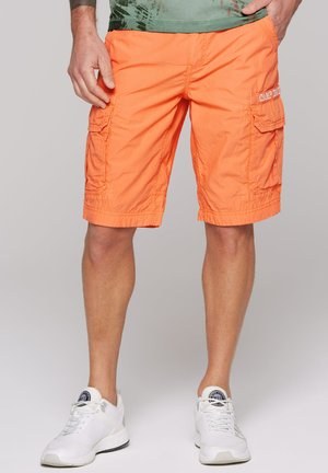 Orange cargo shorts made of lightweight fabric, featuring multiple pockets, stitched accents, and an elastic waistband for comfort.