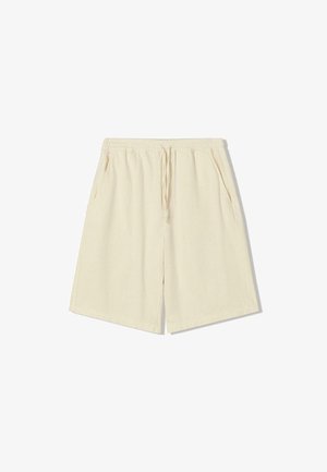 Beige shorts with an elastic waistband, drawstring, and side pockets; made of textured fabric with a relaxed, straight fit.