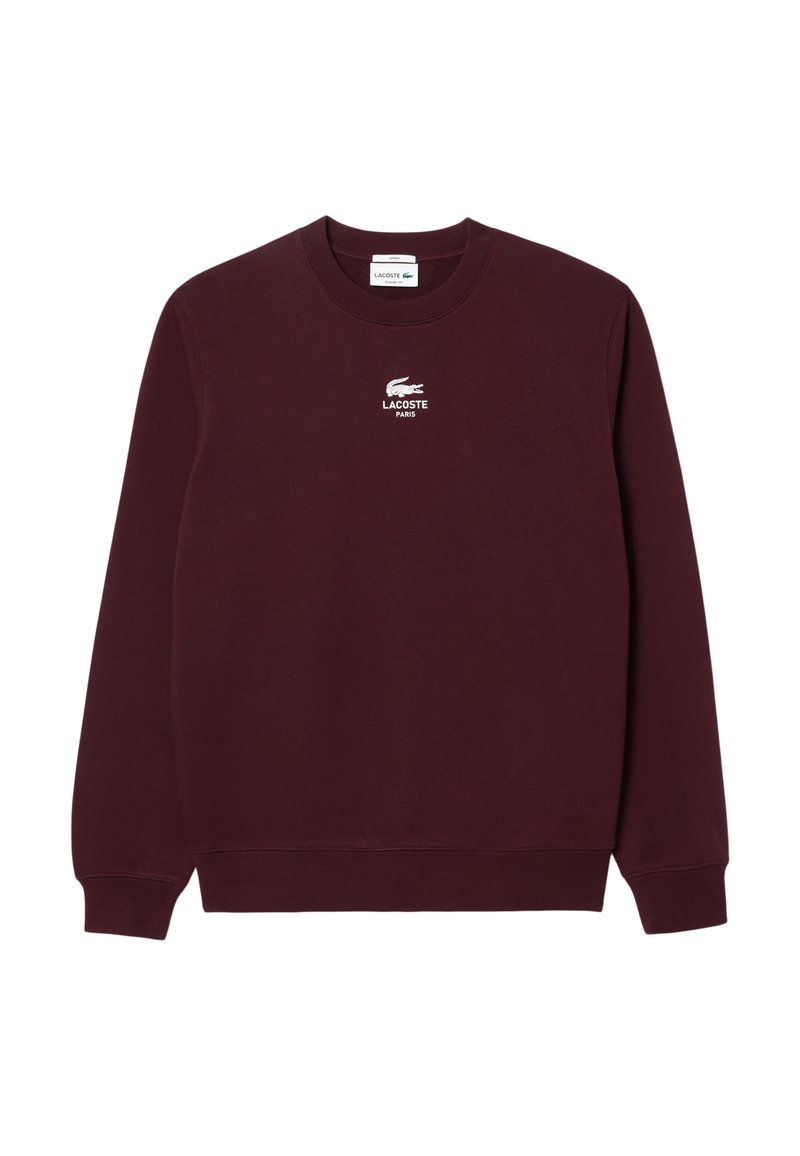 Sweatshirt bordeaux en tissu doux, avec un col rond, des manches longues et un logo Lacoste brodé blanc sur la poitrine.