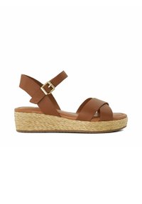 Brown leather wedge sandal with crisscross front straps, ankle strap with gold buckle, and woven straw platform sole.