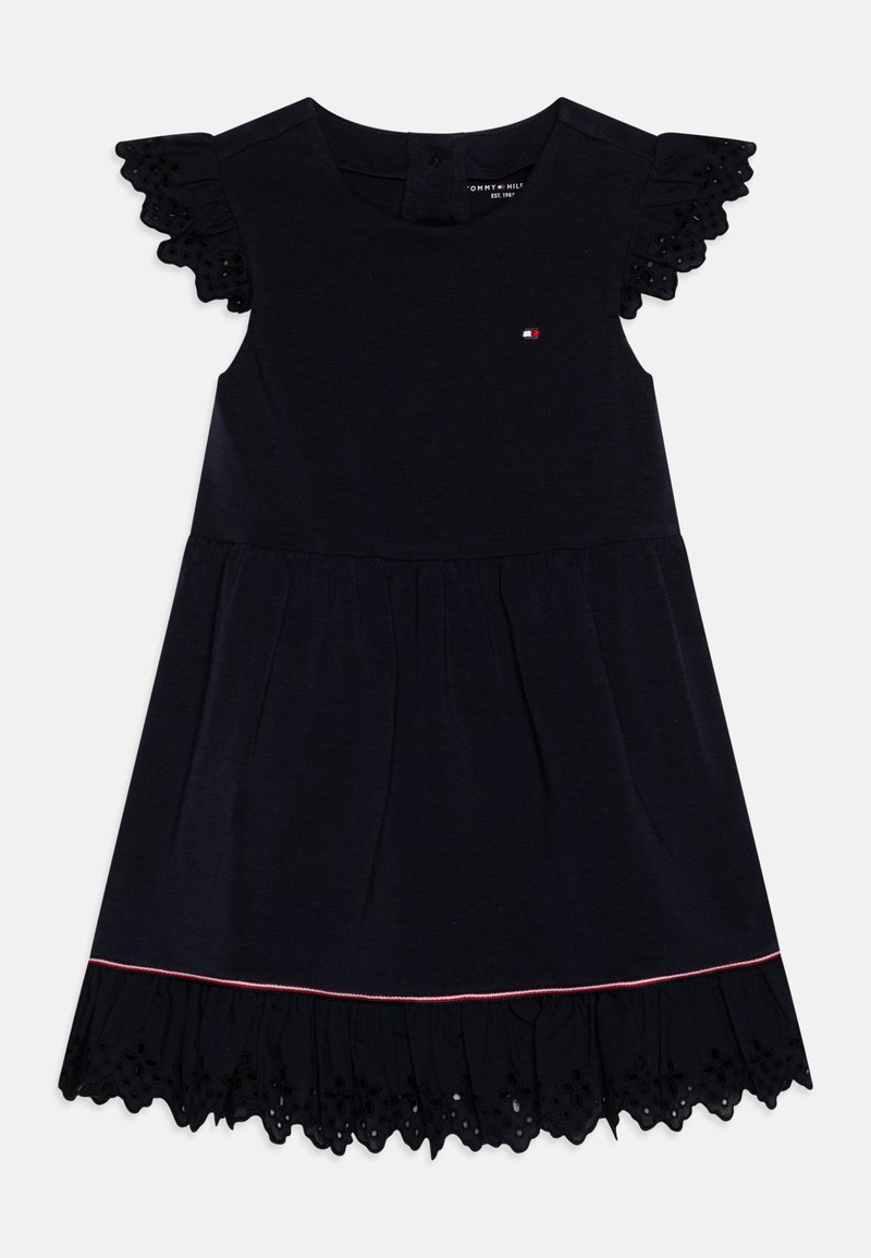 Vestido azul-marinho com mangas curtas e franzidas, bainha de renda decorativa e detalhe bordado subtil. Tecido de algodão suave, silhueta em A.