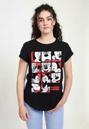 Schwarzes T-Shirt mit einem Gitter aus Mickey Mouse Köpfen in Weiß und Rot. Rundhals, umgeschlagene Kurzärmel und eine lockere Passform.