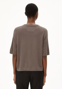Brauner gerippter Strickpullover mit kurzen Ärmeln, lockerer Passform und quadratischem Ausschnitt. Hat ein kleines horizontales Etikett auf der Rückseite.