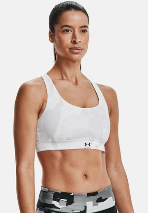 Witte sportbeha met een subtiel camouflagepatroon, voorzien van een ronde halslijn, brede banden en het Under Armour-logo op de tailleband.
