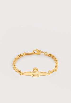 Gold chain bracelet with oval and cross-shaped central charms featuring small embedded crystals and a lobster clasp closure.