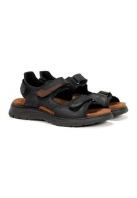 Sandalias de cuero negro con detalles en marrón, que cuentan con correas ajustables, una plantilla acolchada y una suela de goma texturizada para mayor agarre.
