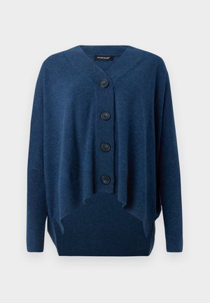 Námořnický modrý cardigan vyrobený z měkké tkaniny, s výstřihem do V, pěti velkými knoflíky a vroubkovaným lemem. Uvolněný střih s asymetrickým zakončením.