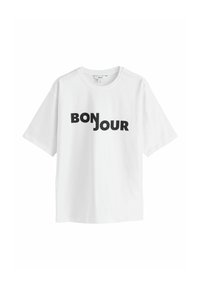 Hvid bomulds t-shirt med korte ærmer. Har sort tekst med ordene "BONJOUR" i en legende skrifttype. Klassisk rund halsudskæring, afslappet pasform.