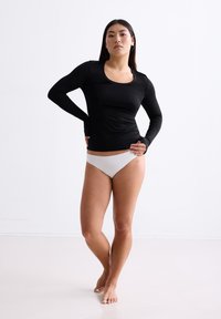 Zwart lange mouwen top met een ronde hals, gecombineerd met lichtgrijze onderkleding. Glad materiaal, nauwsluitend ontwerp en minimalistische uitstraling.