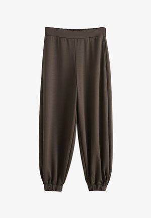 Tmavohnedé voľné nohavice s elastickým pásom a manžetami, bočné vrecká, vyrobené z hladkej, ľahkej látky.
