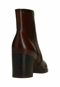 Brown leather ankle boot with stacked block heel and side panel stitching on white background.