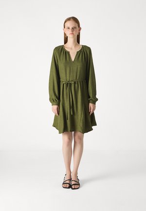 Green linen dress with long sleeves, V-neckline, elastic cuffs, waist tie, and flared skirt. Features side pockets and a textured fabric.