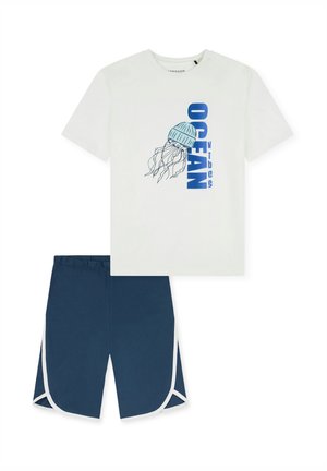 White cotton t-shirt with blue jellyfish graphic and "OCEAN vibes" text; paired with navy shorts featuring white trim and an elastic waistband.