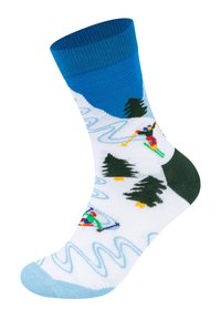 Ponožky s lyžařskou tematikou, s modrým horním lemem, bílým t ělem a designy s lyžaři, zelenými akcenty a zasněženými horami v pozadí.