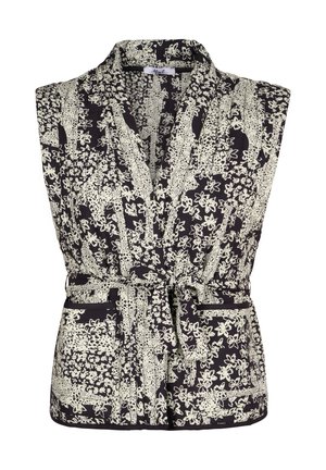 Zwart mouwloos vest met wit bloemen- en stippenpatroon, een ceintuur om de taille en opgestikte zakken aan de voorkant.