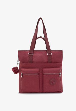 Sac fourre-tout bordeaux avec deux poches zippées à l'avant, doubles poignées et un petit porte-clés en peluche en forme de singe attaché sur le côté gauche.