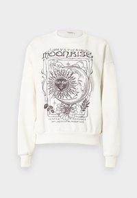 Εκρού φούτερ με ουράνια σχέδια, όπως ήλιος, φεγγάρι και ανθισμένες λεπτομέρειες, με ριμπ μανσέτες και τελείωμα.