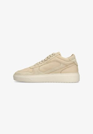 Beige suede sneakers with a smooth leather accent, flat laces, and a rubber sole, featuring a minimalist design and rounded toe.