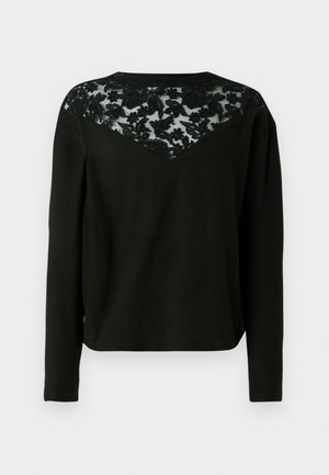 Black long-sleeve top featuring a sheer lace back with floral pattern, rounded neckline, and a relaxed fit. Soft fabric and contrasting textures.