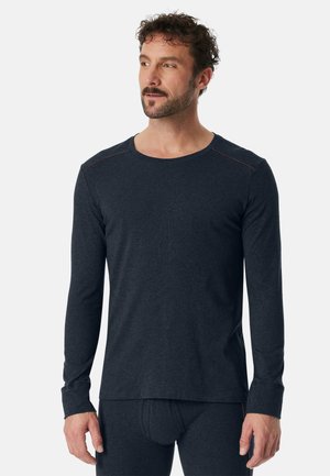 Dunkelgraues Langarmshirt aus glattem, weichem Stoff. Mit rundem Ausschnitt, kontrastierenden Nähten und tailliertem Design.