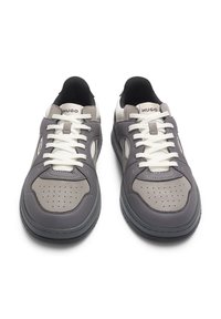 Grey sneakers with textured leather, white laces, and rubber soles. Features perforated accents and a padded collar for comfort.
