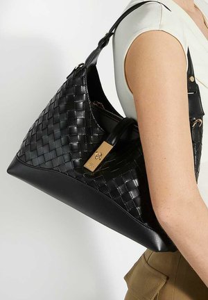 Black woven leather handbag with a smooth matte finish, triangular shape, and gold hardware detail. Adjustable strap included.