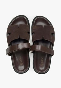 Brown leather sandals with a suede upper, featuring cut-out designs, a strap across the instep, and a textured black rubber sole.