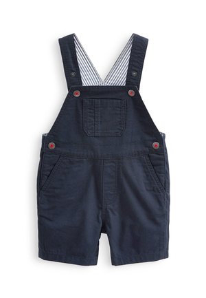 Salopette courte bleu marine pour tout-petit avec boutons rouges, poche avant, poches latérales et doublure rayée sur les bretelles.