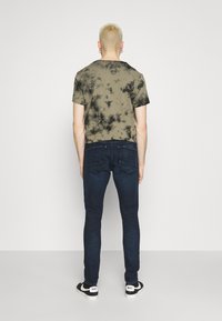 G-STAR REVEND SKINNY - Calças de ganga de corte skinny - worn in ultramarine