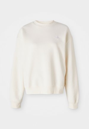 Sweatshirt couleur crème en tissu doux, avec un col rond, des poignets côtelés et un petit logo ton sur ton sur la poitrine gauche.