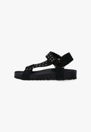 Zwartesuède sandaal met studded bandjes, een verstelbaar enkelbandje en een platte rubberen zool. Eenvoudig ontwerp met open teen.