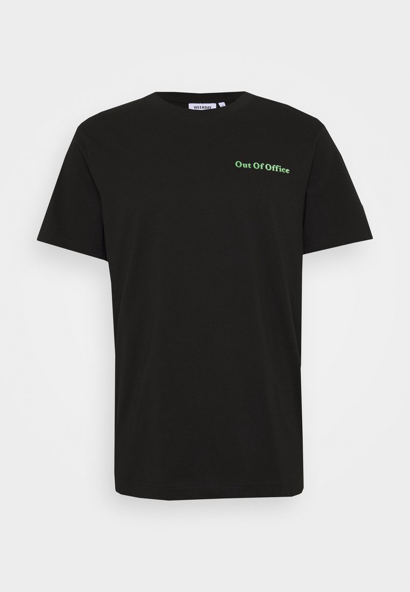 T-shirt en coton noir à manches courtes, avec le texte "Out Of Office" en vert sur la zone de la poitrine gauche. Design classique à col rond.