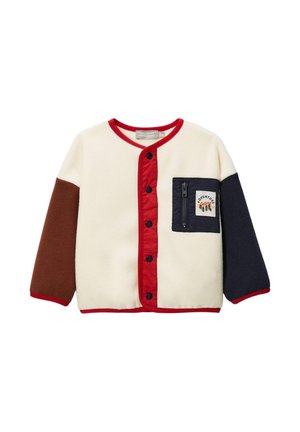 Veste en polaire couleur crème, marron, bleu marine et rouge. Dotée d'une poche zippée sur la poitrine et de boutons-pression à l'avant. Texture douce et design décontracté.