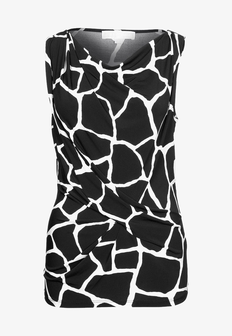 Haut sans manches noir et blanc avec un motif géométrique irrégulier et un détail drapé sur le devant.
