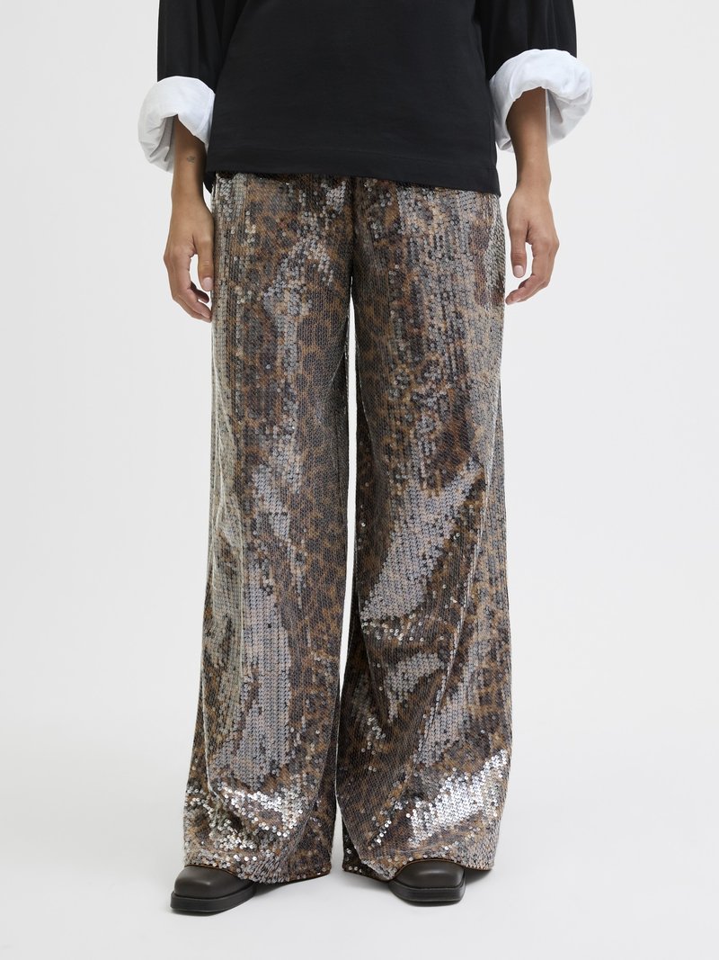 Wide-leg pants featuring a snake skin pattern with sequins in shades of brown, gray, and silver. Smooth texture, paired with a black top.