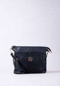 Black leather crossbody bag with a gold hardware logo, zip closure, and an exterior pocket, featuring a smooth texture and adjustable strap.