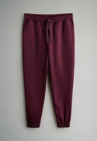 Bordo sporta bikses, kas izgatavotas no elastīga auduma, ar elastīgu jostu un auklu, sānu kabatām un elastīgiem aprocēm pie potītēm.