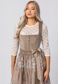 Brown suede dress with a fitted bodice, zip closure, and bow at the waist. The skirt features intricate floral embroidery and a textured top.