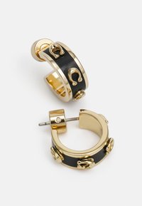 Gold hoop earrings with a black central band, featuring decorative horseshoe accents and a stud post closure. Smooth texture and rounded shape.