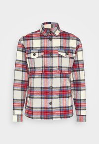 Czerwona, niebieska i beżowa koszula flanelowa w kratę z kołnierzykiem button-down, dwiema kieszeniami na piersi i zapięciem na guziki. Teksturowana tkanina z akcentami teksturowymi.