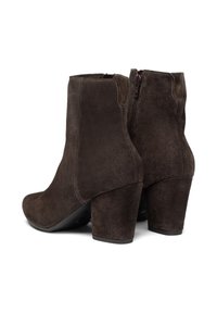 Un paio di stivaletti alla caviglia in suede marrone scuro con tacco a blocco e chiusure con zip laterale, esposti su uno sfondo bianco.