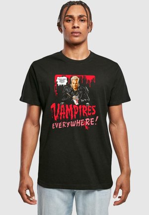 Black t-shirt featuring a graphic design of a blond character in a leather jacket, blood-red drips, and bold text reading "VAMPIRES EVERYWHERE!"