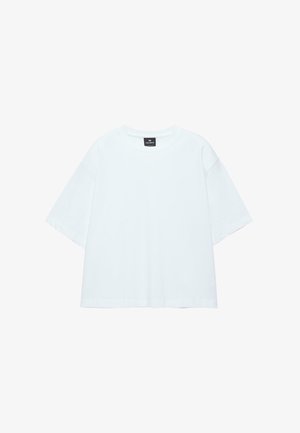 T-shirt blanc uni en coton à manches courtes avec col rond et étiquette noire au niveau de l'encolure, présenté à plat sur un fond blanc.