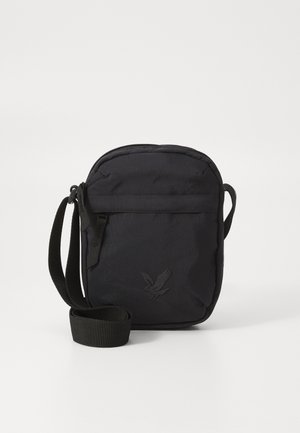 Czarna materiałowa torba na ramię z zamkiem błyskawicznym, krótkim paskiem i teksturowaną powierzchnią. Z przodu znajduje się subtelne wytłoczone logo.