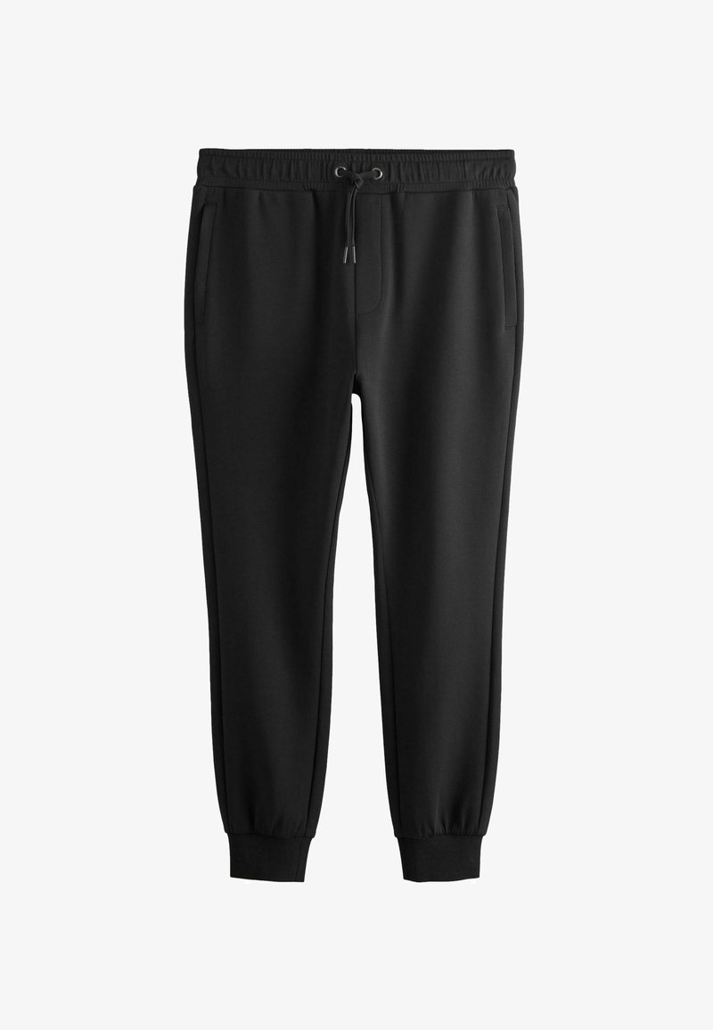 Pantalon de survêtement noir fuselé avec taille élastique, cordon de serrage, poches latérales et poignets côtelés aux chevilles.