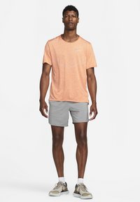 Nike Performance RISE - T-shirt desportiva - orange trance/htr/(reflective silv)