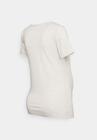 Camiseta de manga corta en gris claro, hecha de una tela suave y texturizada. Presenta un escote redondo y un corte relajado con un dobladillo ligeramente curvado.